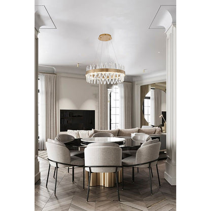 Gold and crystal round chandelier installed in a bright modern dining area, emphasizing its clean, architectural lines.