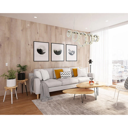 Modern 39-inch Chrome Ring crystal chandelier with five interlocking rings installed over a contemporary grey sofa in a living room.
