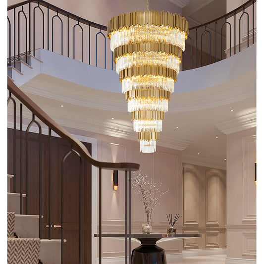 78-inch Brushed Brass Cascading crystal chandelier installed in a grand two-story entryway with a curved staircase.