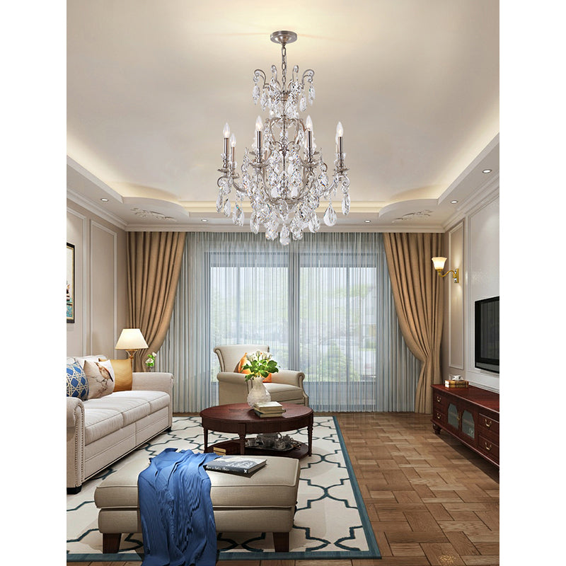 32-inch pewter 2-tier crystal chandelier installed in a traditional living room with neutral decor and gold curtains.