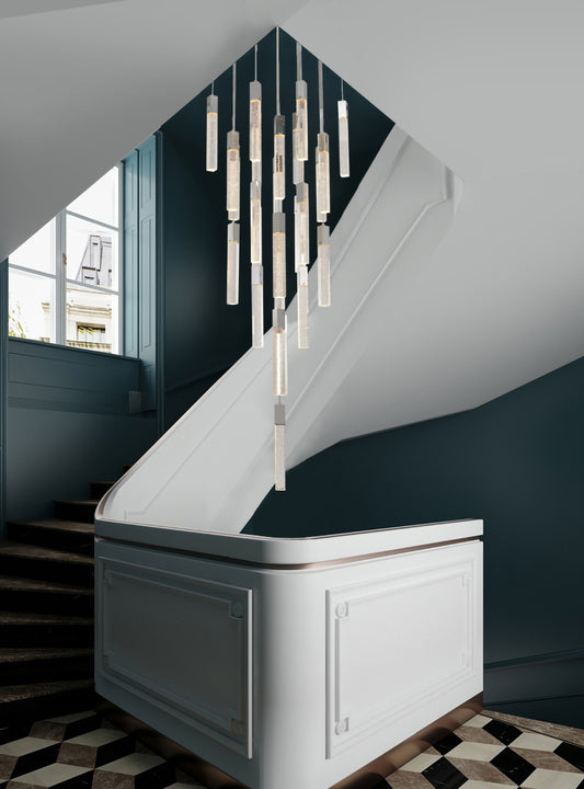 The ADS05C25CH 25-light chrome chandelier suspended in an elegant foyer with a white curved staircase, creating a dramatic focal point.