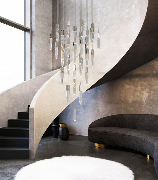 The ADS21C41CH 41-light chrome chandelier suspended in a dramatic curved staircase area with a dark sofa and white shag rug.