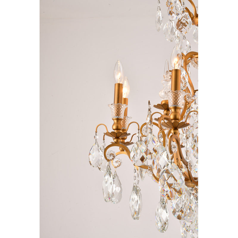 Profile view of the brass candelabra arms and faceted crystal drops on the tiered dining room fixture.