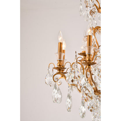 Profile view of the brass candelabra arms and faceted crystal drops on the tiered dining room fixture.