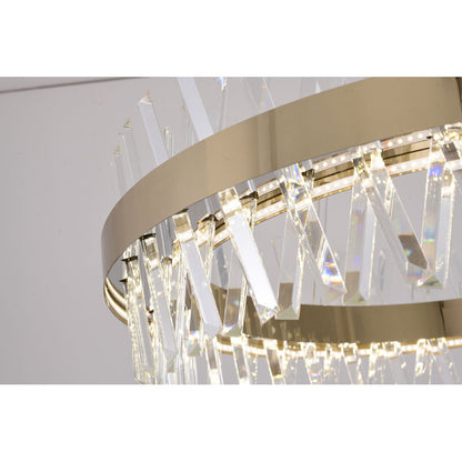 Detailed view of the golden ring chandelier illuminated, showing the internal light reflecting through crystal shards.